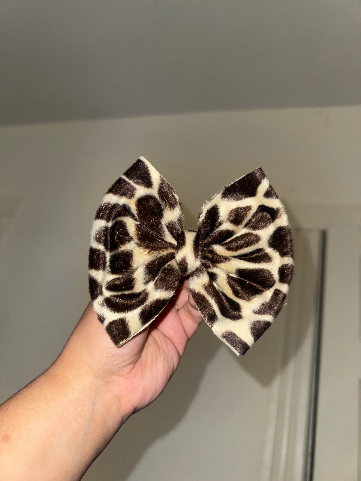 Furry giraffe print bow